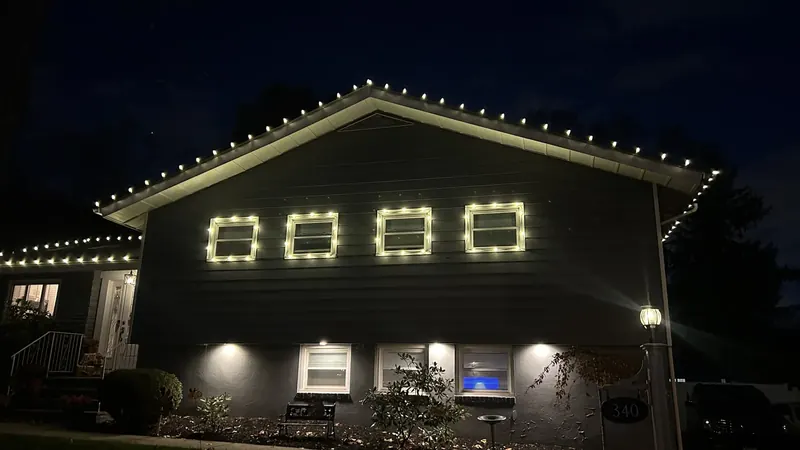 Kasa warm white lights along a home's roof and upper windows in Mountainside